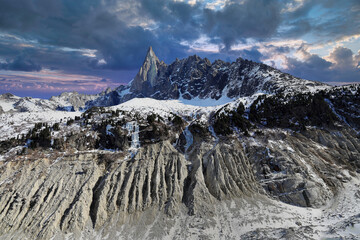 Aiguille du Dru mountain in the Mont Blanc massif on the glacier Mer de Glace. French Alps, Europe.