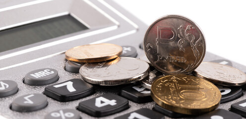 Coin with Russian ruble symbol and calculator