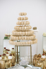 Pyramid of vanilla macarons at a wedding candy bar	