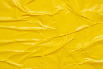 Blank yellow crumpled and creased paper poster texture background