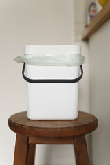 Compact bokashi container in a kitchen. Compost bin for recycling organic food waste at home. Sustainable lifestyle concept