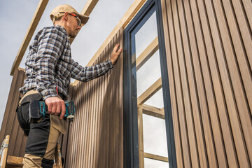 Construction Worker Building Modern Composite and Wood Made Shed