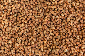 Brown buckwheat groats. Health and natural products. Close-up. Background. Space for text.