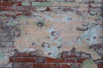 Old painted rouge worn brick wall 