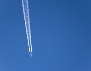 commercial plane flying against blue sky