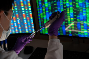 Male researcher in front of genome screens.