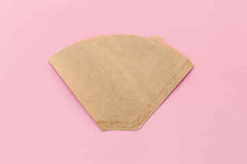 Eco coffee filter isolated on minimal pastel light pink background. Pour over method, organic zero vaste unbleached paper