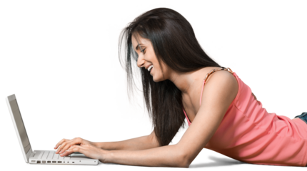 Young woman lying down in front of a laptop