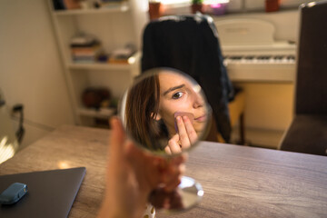 Close up photo of woman doing make up, mirror reflection. 