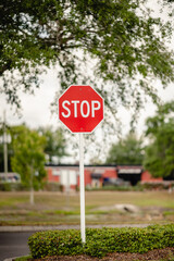 Stop sign outside on the road in North America with a building behind