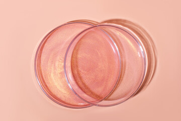 Liquid rose gold. Or a pink liquid with glitter. In Petri dishes. Laboratory research of cosmetics, gel, medicine. Chemistry