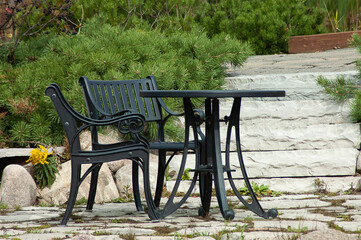 black metal coffee table with chairs in the park
