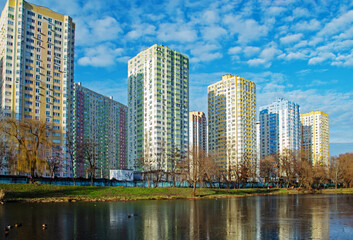 Fototapeta na wymiar Residential area in Kyiv near the park, on the shore of a small lake