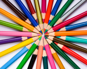 Many different colored pencils on white background, Colored pencils in arrange in color wheel colors on white background, Group of multicolor pencils.