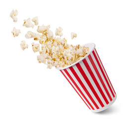 A striped bucket with flying popcorn isolated on a white background. - obrazy, fototapety, plakaty