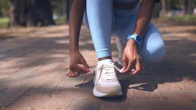 Hands, tie shoes and fitness outdoor to start running, exercise or training at park. Sports, athlete and woman tying sneakers to get ready for cardio, workout or exercising for health and wellness.