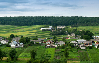 Fototapeta na wymiar Bird's eye view of fields or farmland and settlements with houses.