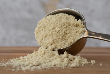 Coconut Protein Powder Spilled from a Scoop