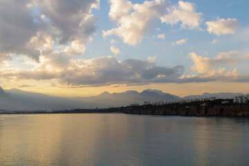 Fototapeta na wymiar Landscape of Mediterranean sea with mountains in the distance during the sunset, Antalya, Turkey