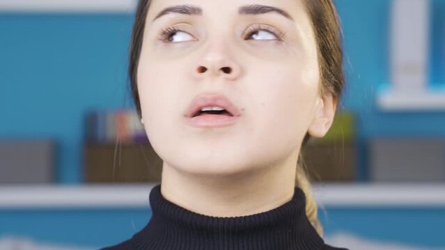 Close-up of young woman shrinking and depressed.
Depressed young woman at home panics, can't breathe, constricts.
