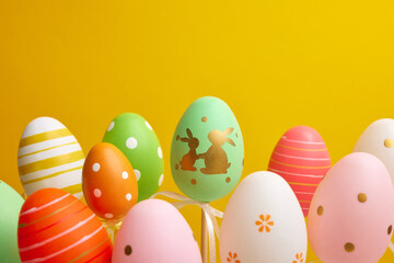 multi-colored easter eggs on a yellow background, easter holiday