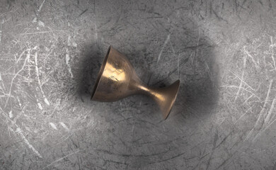 ancient bronze goblet on iron background