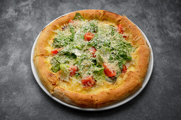 Delicious Caesar pizza displayed on wood board