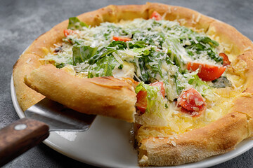 Delicious Caesar pizza displayed on wood board