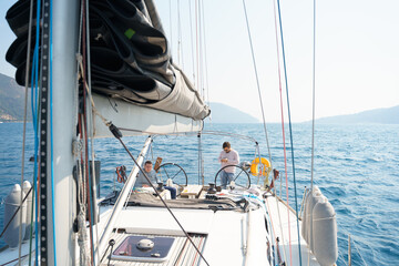 Businessman, owner with mobile phone at steering wheel in voyage sail on sport sea luxury yacht....