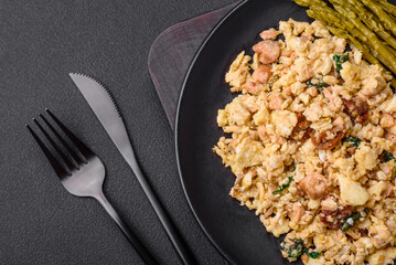 Delicious scramble with salmon, sun-dried tomatoes, spinach, spices and herbs