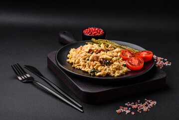 Delicious scramble with salmon, sun-dried tomatoes, spinach, spices and herbs