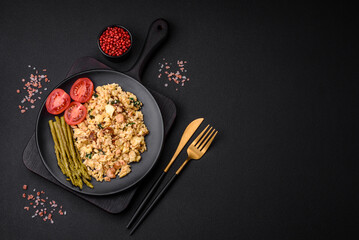 Delicious scramble with salmon, sun-dried tomatoes, spinach, spices and herbs