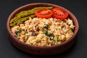 Delicious scramble with salmon, sun-dried tomatoes, spinach, spices and herbs