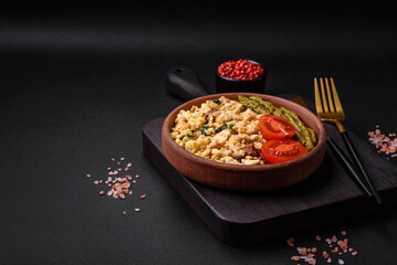 Delicious scramble with salmon, sun-dried tomatoes, spinach, spices and herbs