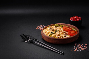 Delicious scramble with salmon, sun-dried tomatoes, spinach, spices and herbs