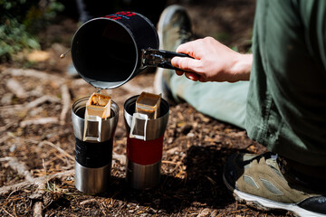 Brew a filter bag of coffee in nature, hand pours boiling water into a glass of coffee, a quick...