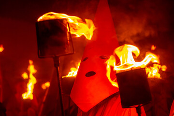 Close em um farricoco, segurando uma tocha com fogo, na procissão do Fogareu, festa típica da...