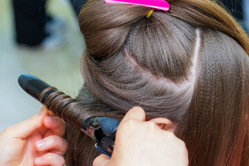 The process of creating hairstyles, hair care. Background, selective focus.