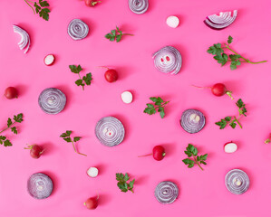 Fresh red onions, radish and parsley on pink background. Healthy spring food wallpaper. Flat lay. Top view.