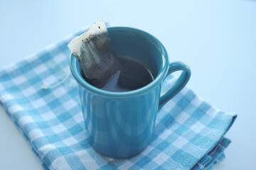 green tea and tea bag on table, close up.