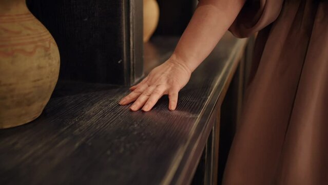 A woman's hand slides across the table