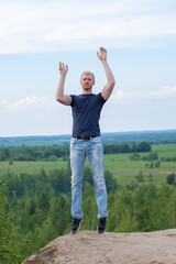 A man surrounded by mountains and forests. A man in a jump