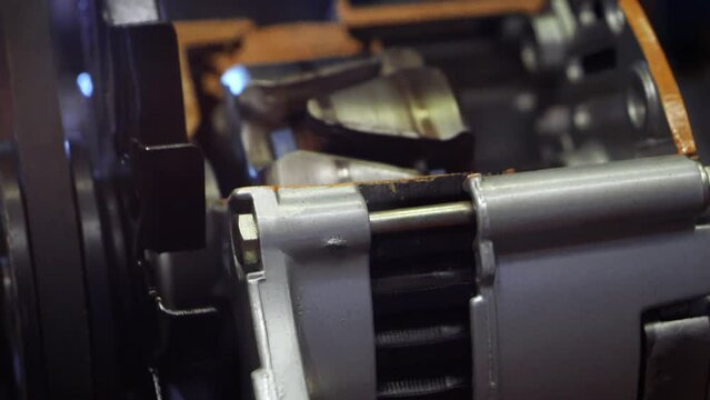 Closeup of metal details inside car engine moving and rotating.