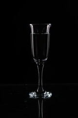A glass of water on a black background
