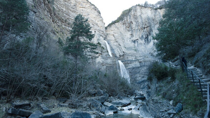 Fototapeta na wymiar high waterfall next toa fresh water river in the pyrenees