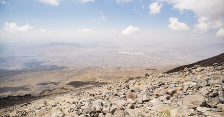 Rocky slope made of stones on Mount Ararat on a sunny summer day with clouds, slopes with scree
