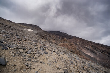 Rocky slope made of stones on Mount Ararat on a sunny summer day with clouds, slopes with scree