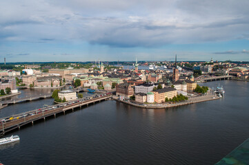 Fototapeta na wymiar Stockholm, Sweden - July 20, 2015: City skyline with water canals, old buildings and embankment with bridges