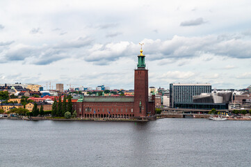 Stockholm, Sweden - The embankment with the brick building of the town hall with an observation...
