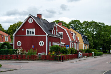 Classic wooden colorful houses in Sweden. A street in a small town in northern Europe.